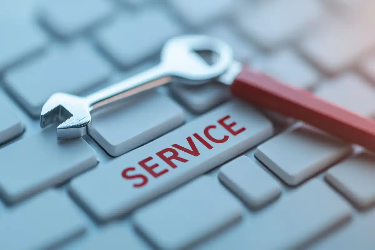 wrench placed on keyboard key labeled service in red text